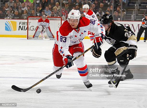 Jay Beagle of the Washington Capitals moves the puck up ice in front of the defense of Matt Niskanen of the Pittsburgh Penguins on January 15, 2014...