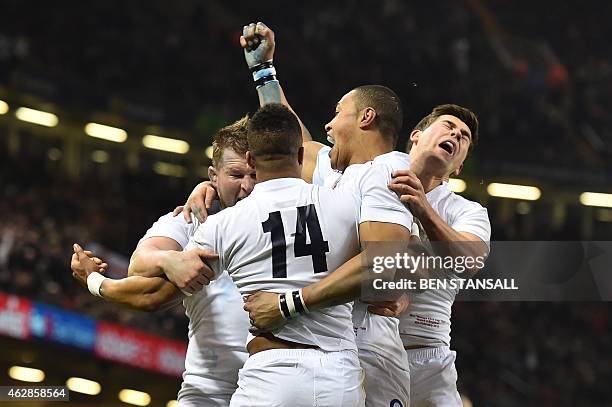 England's wing Anthony Watson celebrates with team-mates after scoring a try during the Six Nations international rugby union match between Wales and...