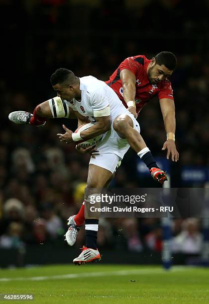 Anthony Watson of England caims a high ball under pressure from Toby Faletau of Wales during the RBS Six Nations match between Wales and England at...