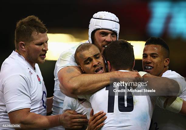Jonathan Joseph of England celebrates his try with team mates during the RBS Six Nations match between Wales and England at the Millennium Stadium on...