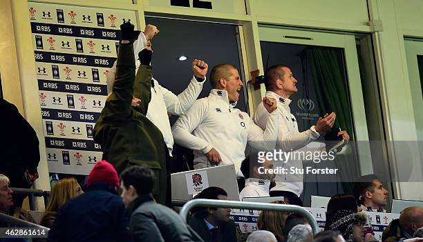 England coach Stuart Lancaster and his staff celebrate victory from their box during the RBS Six Nations match between Wales and England at Millenium...