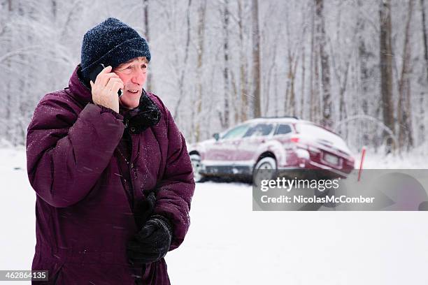 senior man calling for help during snow storm - bilar i snö bildbanksfoton och bilder