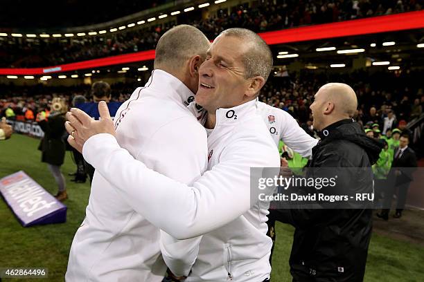 Stuart Lancaster the head coach of England celebrates with Mike Catt the England attacking skills coach following their team's 21-16 victoryduring...