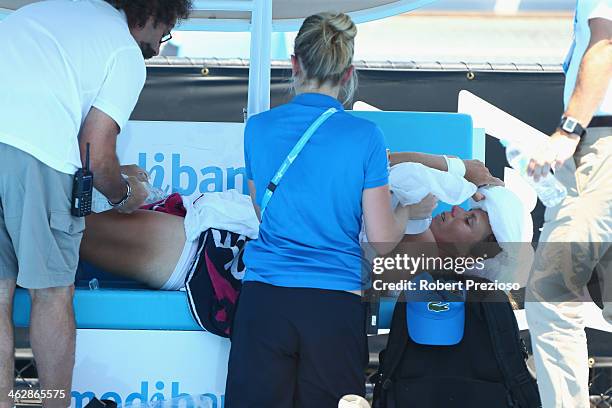 Varvara Lepchenko of the USA is treated by medical staff during day four of the 2014 Australian Open at Melbourne Park on January 16, 2014 in...