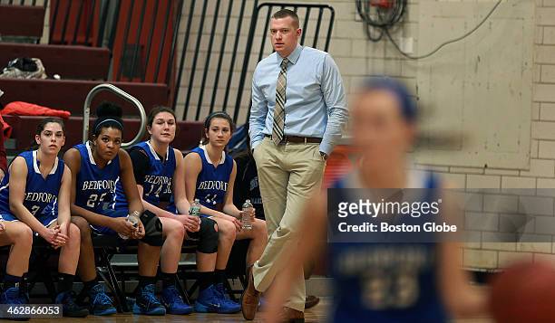 Matt Ryan, head coach of the Bedford High School girl's basketball team on the sideline during a game against Weston High School.