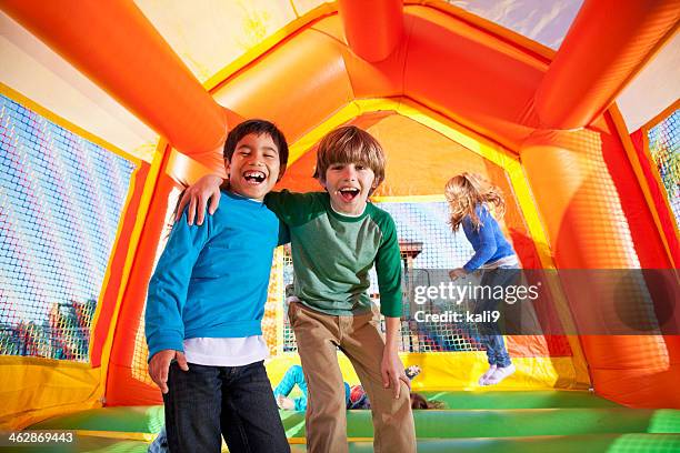 boys in bounce house - bouncing stock pictures, royalty-free photos & images