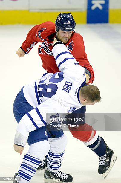 John Erskine of the Washington Capitals fights against Colton Orr of the Toronto Maple Leafs at Verizon Center on January 10, 2014 in Washington, DC.