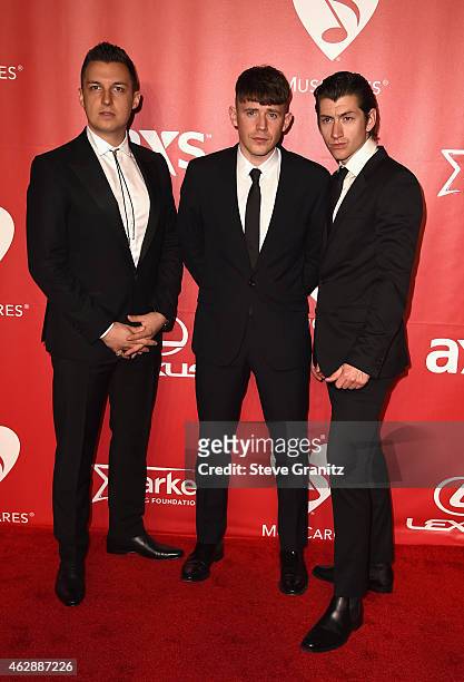 Musicians Matt Helders, Jamie Cook, and Alex Turner of Arctic Monkeys attend the 25th anniversary MusiCares 2015 Person Of The Year Gala honoring Bob...