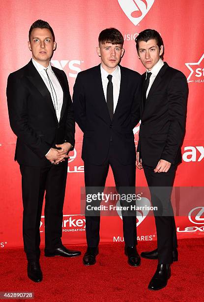 Musicians Matt Helders, Jamie Cook, and Alex Turner of Arctic Monkeys attend the 25th anniversary MusiCares 2015 Person Of The Year Gala honoring Bob...