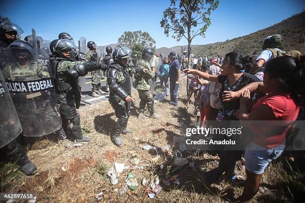 Police officers try to move away Mexicans who want to stage a protest after Mexico police found dozens of bodies in Acapulco, Mexico on Februay 6,...