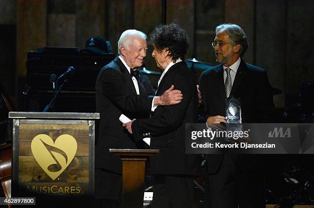 Honoree Bob Dylan accepts award from former President Jimmy Carter and president of the National Academy of Recording Arts and Sciences Neil Portnow...