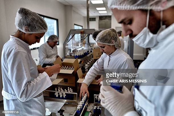 Employees of the Apivita ecological cosmetic company pack products at the company workshops in Markopoulo, south of Athens, on February 2, 2015....