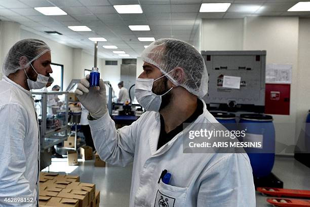 An employee of the Apivita ecological cosmetic company checks products at the company workshops in Markopoulo, south of Athens, on February 2, 2015....