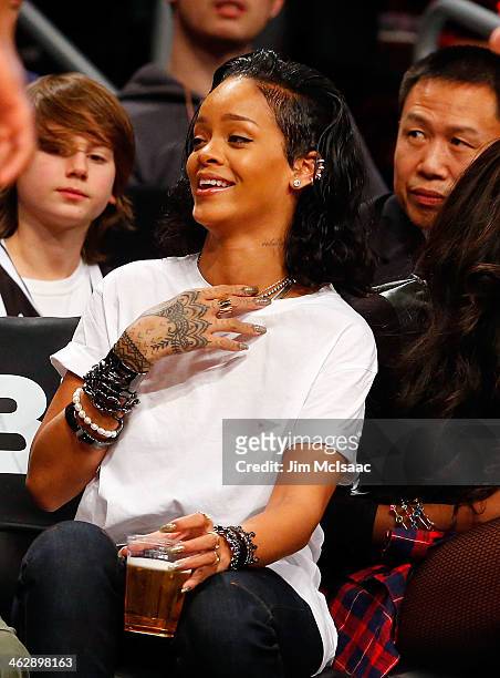 Singer Rihanna attends an NBA game between the Brooklyn Nets and the Miami Heat at Barclays Center on January 10, 2014 in the Brooklyn borough of New...