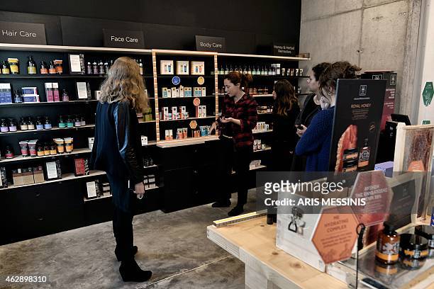 Women look at products of the Apivita ecological cosmetic company in Markopoulo, south of Athens, on February 2, 2015. Helped by its wide variety of...