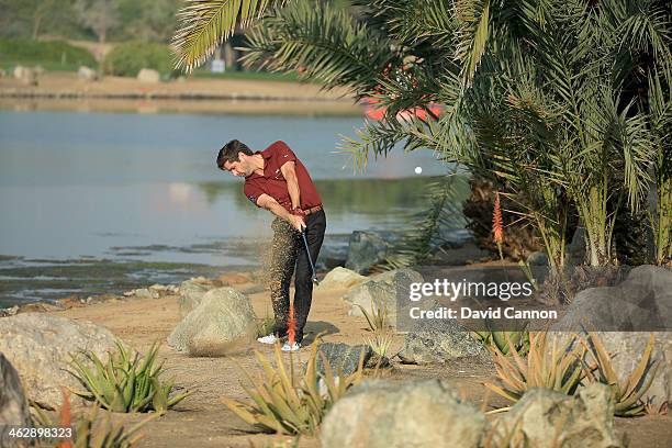 Robert Rock of England plays his second shot at the par 4, 14th hole during the first round of the 2014 Abu Dhabi HSBC Golf Championship at Abu Dhabi...