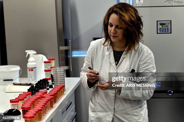 An employee of the Apivita ecological cosmetic company checks products at the company workshops in Markopoulo, south of Athens, on February 2, 2015....