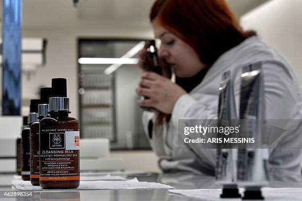 An employee of the Apivita ecological cosmetic company checks products at the company workshops in Markopoulo, south of Athens, on February 2, 2015....