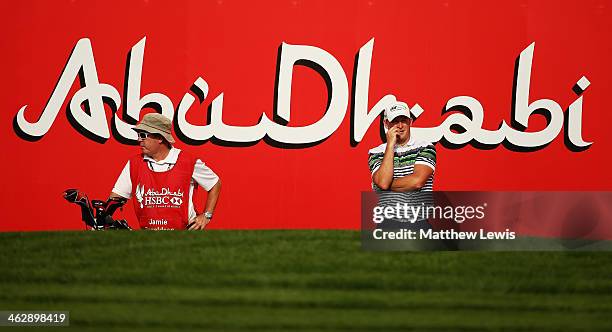 Jamie Donaldson of Wales looks on with his caddie Mick Donaghy during day one of the Abu Dhabi HSBC Golf Championship at Abu Dhabi Golf Club on...