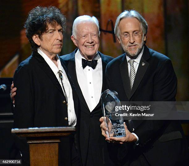From left, Bob Dylan, Former United States President Jimmy Carter and National Academy of Recording Arts and Sciences President Neil Portnow speaks...
