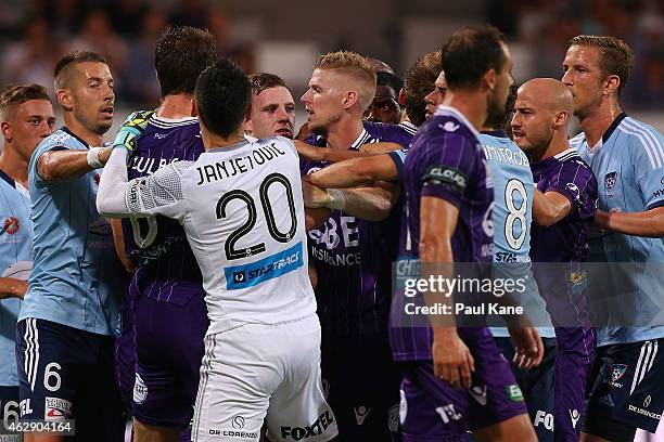 Players wrestle after an altercation between Dino Djulbic of the Glory and Jacques Faty of Sydney during the round 16 A-League match between the...