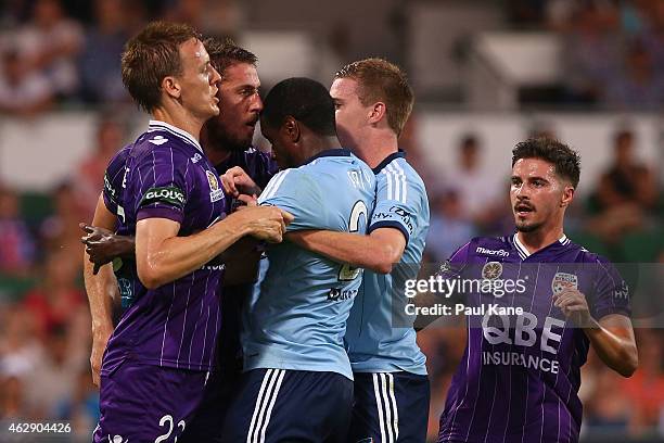 Michael Thwaite of the Glory and Aaron Calver of Sydney attempt to separate Dino Djulbic and Jacques Faty during the round 16 A-League match between...