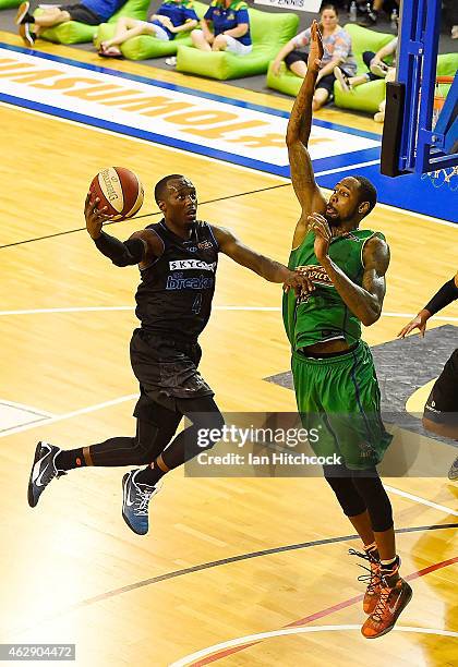 Cedric Jackson of the Breakers attempts a layup past Mickell Gladness of the Crocodiles during the round 18 NBL match between the Townsville...