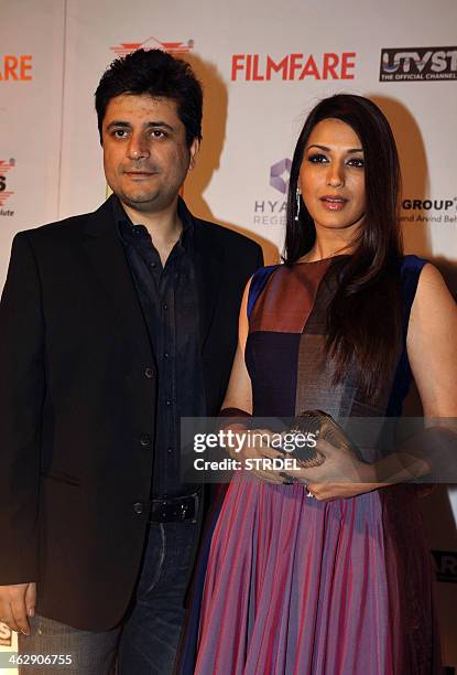 Indian Bollywood actress Sonali Bendre and her husband pose for a photograph during the 59th "Idea Filmfare Awards 2013" pre-awards party in Mumbai...