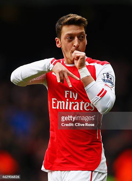 Mesut Oezil of Arsenal celebrates scoring the opening goal during the Barclays Premier League match between Tottenham Hotspur and Arsenal at White...