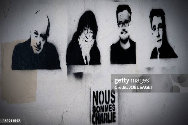 Picture taken shows stencils by French artist Rob.Ink depicting slain cartoonists Wolinski, Cabu, Charb and Tignous and the words "Je suis Charlie"...