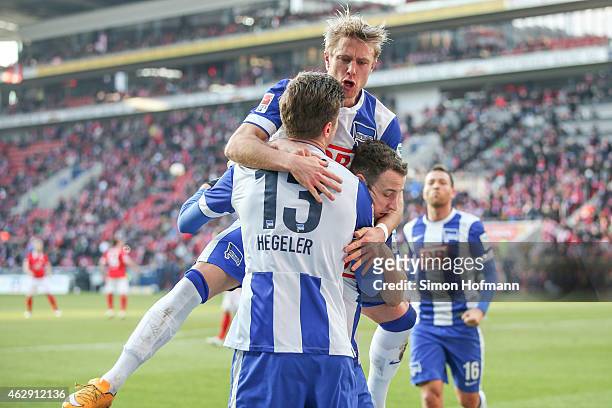 Jens Hegeler of Berlin celebrates his team's first goal with his team mate Per Cijan Skjelbred during the Bundesliga match between 1. FSV Mainz 05...
