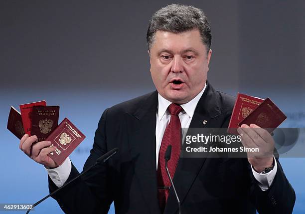 Ukranian President Petro Poroshenko holds up Russian passports during a speech at the 51st Munich Security Conference on February 7, 2015 in Munich,...