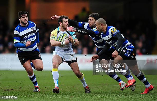 Tom Grabham of Ospreys is tackled by Olly Woodburn and Matt Banahan of Bath during the LV= Cup match between Bath Rugby and Ospreys at Recreation...
