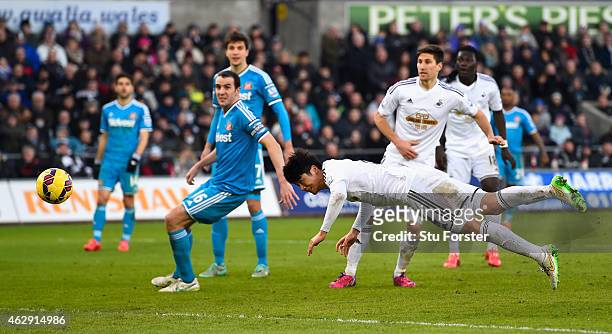 Swansea City player Ki Sung-Yueng dives to head the first Swansea goal during the Barclays Premier League match between Swansea City and Sunderland...
