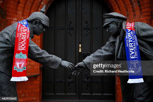 Liverpool and Everton scarves adorn a Christmas Truce statue outside a church near the stadium before the Barclays Premier League match between...