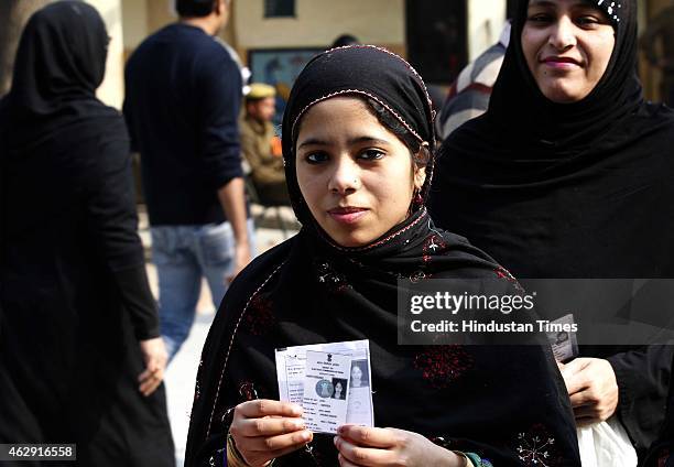 Girl voting for the first time, showing her Voter ID card after casting vote during the Delhi Assembly Elections 2015, on February 7, 2015 in New...