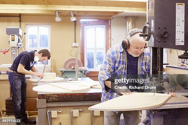 pattern makers measuring and cutting  wood - wood worker posing ストックフォトと画像