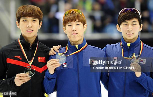 Third placed Dequan Chen of China, winner Sin Da Woon of Korea and his compatriot Park Se Yeong celebrate on the podium after the men's 1500m final...