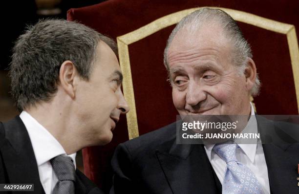 Spain's Prime Minister Jose Luis Rodriguez Zapatero talks with Spain's King Juan Carlos during the Cervantes award ceremony in Alcala de Henares,...