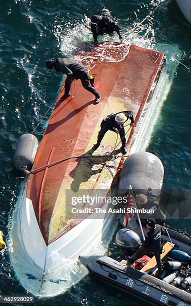 In this aerial image, Japan Coast Guard members investigate the cause of the collision with Japan Maritime Self-Defense Force vessel 'Osumi' around...