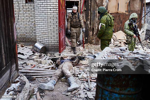 Ukrainian paramilitary is found dead by pro-Russian rebels outside a damaged house on February 7, 2015 in Uglegorsk, Ukraine. According to...