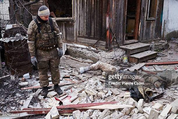 Ukrainian paramilitary is found dead by pro-Russian rebels outside a damaged house on February 7, 2015 in Uglegorsk, Ukraine. According to...