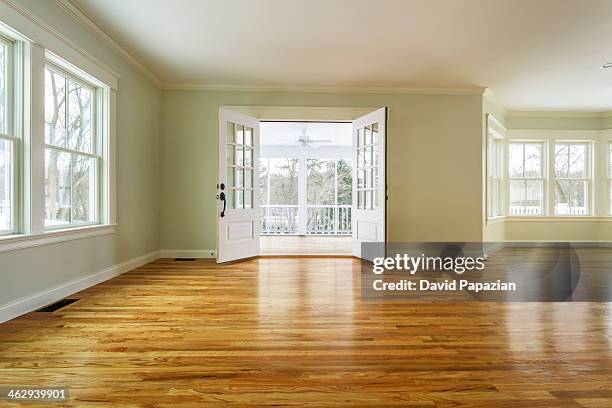 unfurnished family room with hardwood floors - french doors stock pictures, royalty-free photos & images