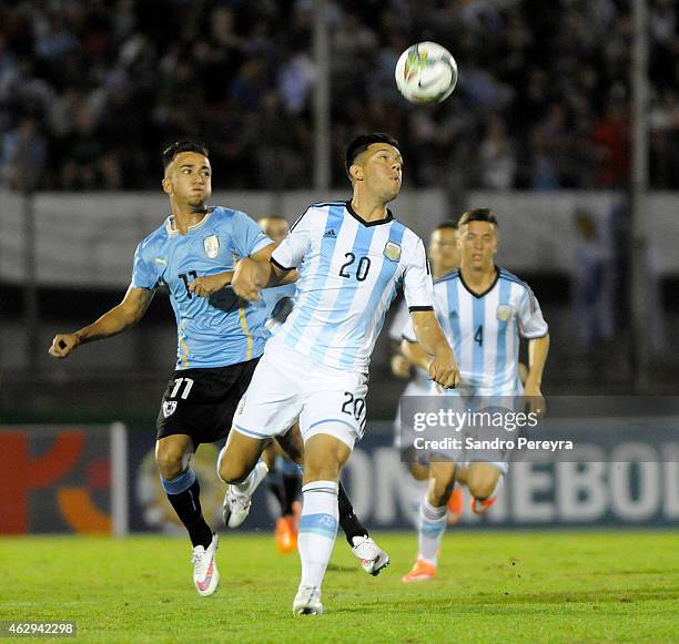 Facundo Monteseirin of Argentina and Franco Acosta of Uruguay fight for the ball during a match between Argentina and Uruguay as part of South...