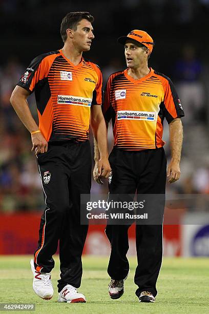 Patrick Cummins and Simon Katich of the Perth Scorchers discuss fielding tactics during the Big Bash League match between the Perth Scorchers and the...