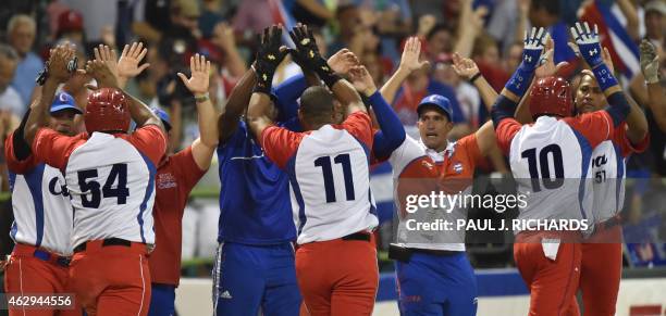 Cuba National baseball team celebrate with high fives for Alfredo Despaigne , Yander Luis La O , and Yulieski Gurriel , after scoring over the...