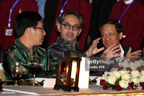 Indonesia's Foreign Minister Marty Natalegawa talks with Vietnam's Foreign Minister Pham Binh Minh and Association of Southeast Asian Nations...