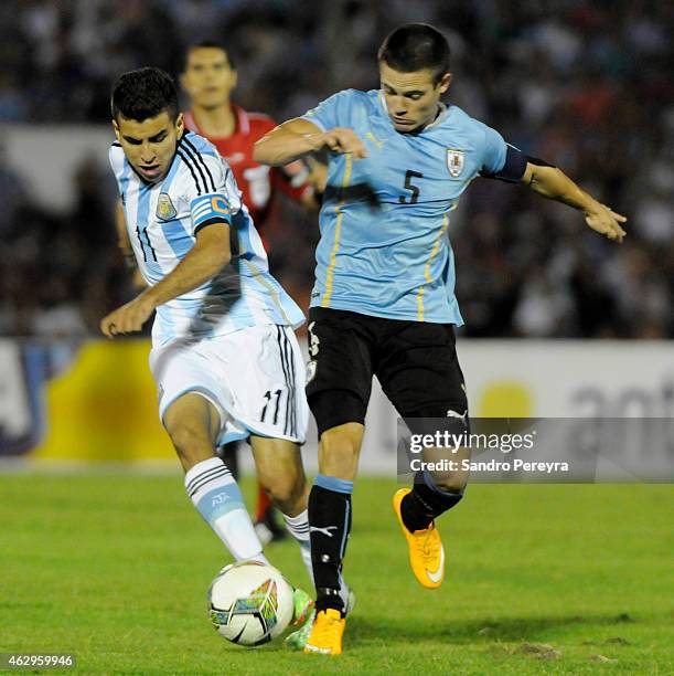 Angel Correa of Argentina and Nahitan Nandez of Uruguay fight for the ball during a match between Argentina and Uruguay as part of South American...