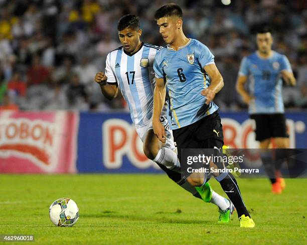 Ramiro Gurra of Uruguay and Joaquin Ibañez of Argentina fight for the ball during a match between Argentina and Uruguay as part of South American...