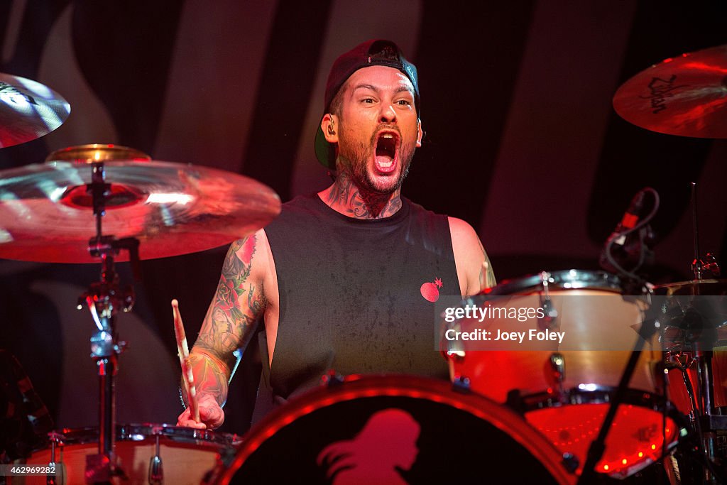 Drummer Mike Fuentes of Pierce The Veil performs in front of a sold